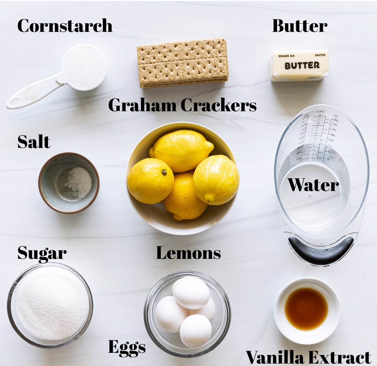 Ingredients to make homemade lemon meringue pie on a counter. 