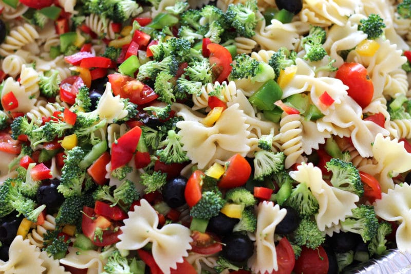 Italian Style pasta salad containing tomatoes, peppers, cheese and broccoli.