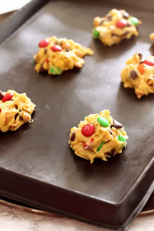 Flexipan containing 5 raw cookie dough balls for Boyfriend Cookies, topped with red and green M&Ms.