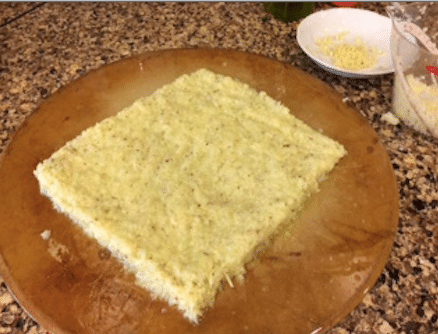 The cheesy garlic cauliflower breadsticks rolled out on the cooking stone prior to baking.