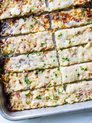 Sliced breadsticks on a cookie sheet.