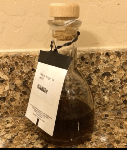 A small glass bottle of balsamic vinegar. 