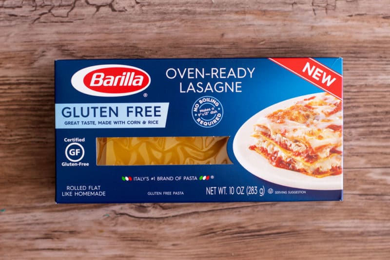 Box of Barilla Oven-Ready gluten free lasagne noodles sitting on a brown table.