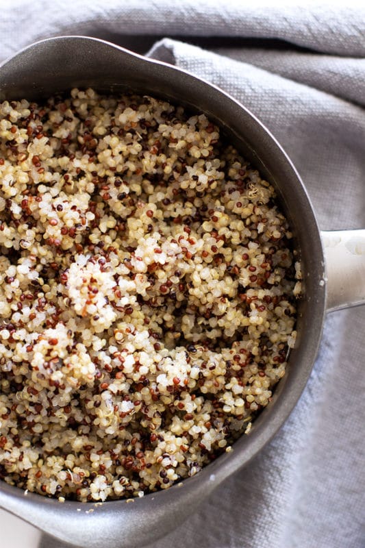 Pot containing cooked red, white and black quinoa.