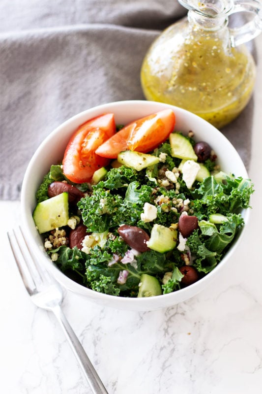 This Greek Kale and Quinoa Salad is a powerhouse salad full of nutrition and fiber! The perfect for any lunch or dinner! Add chicken and you have yourself a meal packed full of protein! This Greek salad is addictively delicious! #greeksalad #kalewithquinoasalad #kalesalad #greekchickensalad | recipesworthrepeating.com
