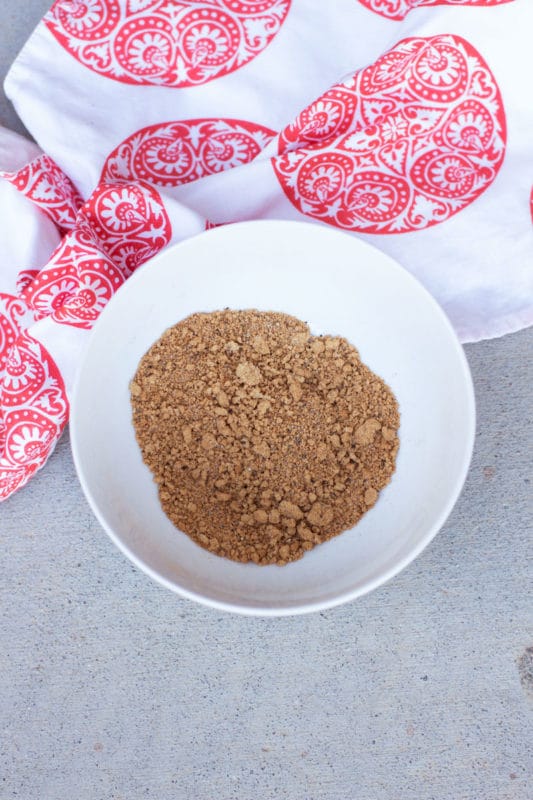 White bowl with a mixture of spices, napkin on side.