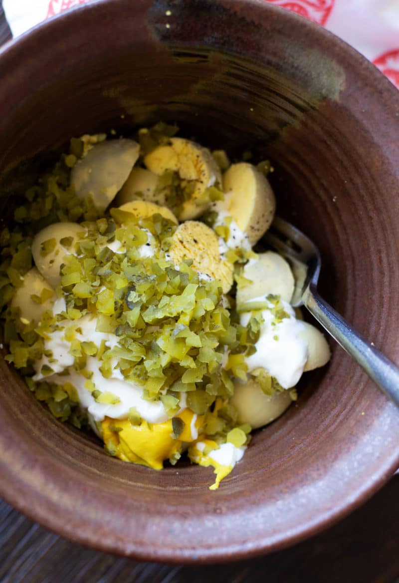 Eggs yolks, relish, mayo, mustard, salt, and pepper in a mixing bowl.