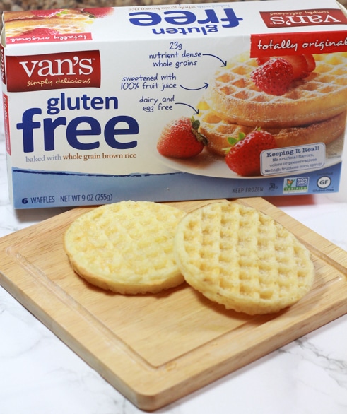 Cutting board with 2 Gluten Free Waffles, box of Van's Gluten Free Waffles on table.