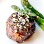 Garlic and rosemary seasoned steak served with grilled asparagus spears.