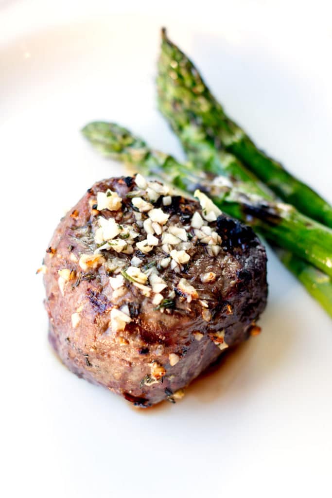 Garlic and rosemary seasoned steak served with grilled asparagus spears.