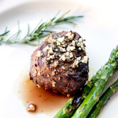 Garlic and rosemary seasoned steak served with grilled asparagus spears.