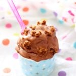 A scoop of chocolate frozen yogurt with cookie crumbles