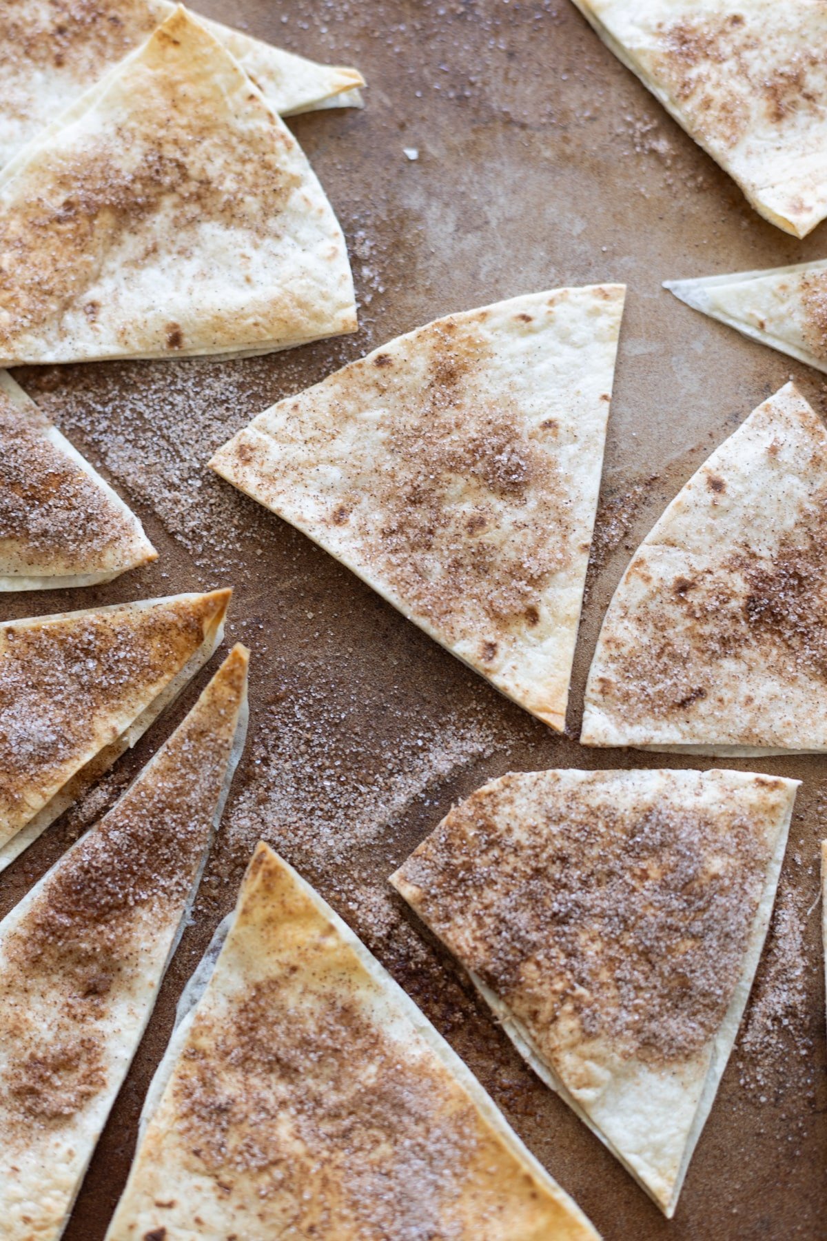 Cinnamon and sugar tortilla chips baking on a platter.