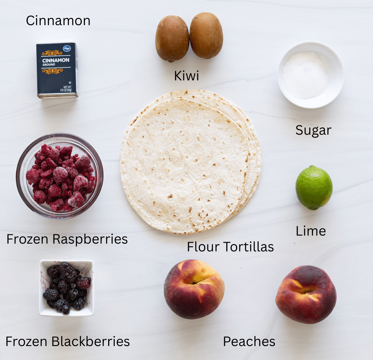 Cinnamon, sugar, fruit, and tortilla shells on a table to make fruit salsa with cinnamon chips. 
