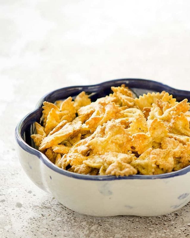 White bowl containing Air Fryer Bow Tie Pasta Chips.