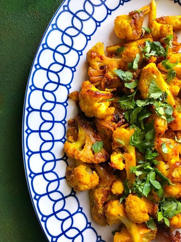 Blue and white plate containing Cauliflower mixed with Indian Spices made in an Instant Pot.