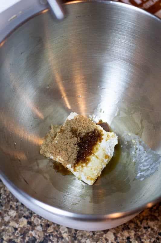 Mixing bowl containing cream cheese, brown sugar and vanilla extract to make Churro Cinnamon Pumpkin Cookies.