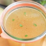 Container filled with homemade bone broth made in an Instant Pot.