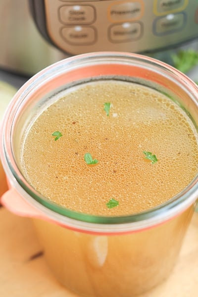 Container filled with homemade bone broth made in an Instant Pot.