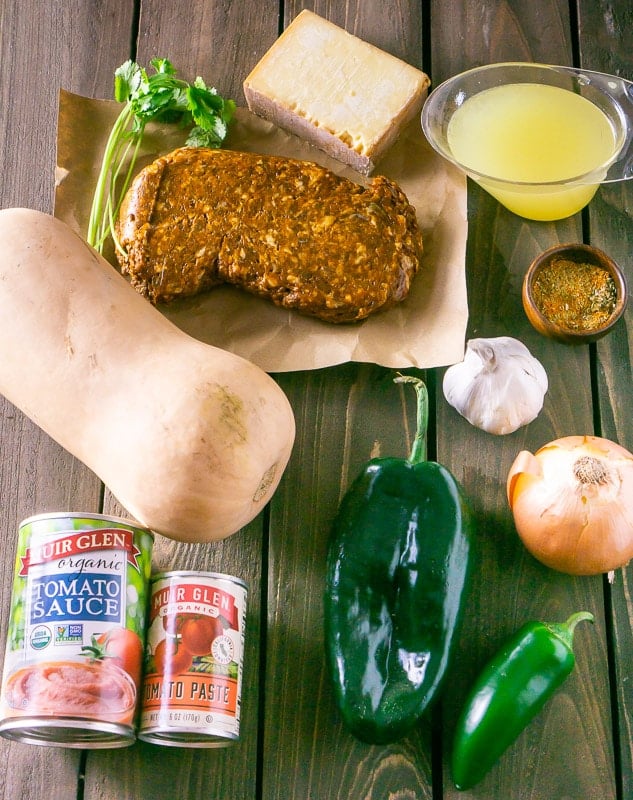 The ingredients for chorizo-butternut squash chile rellenos: butternut squash, chorizo, cilantro, cheese, chicken stock, spices, garlic, onion, jalapeno, pasilla pepper, tomato sauce and tomato paste.