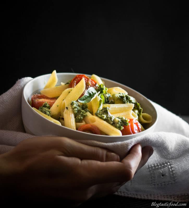 A photo of someone holding a bowl of gluten free pasta.