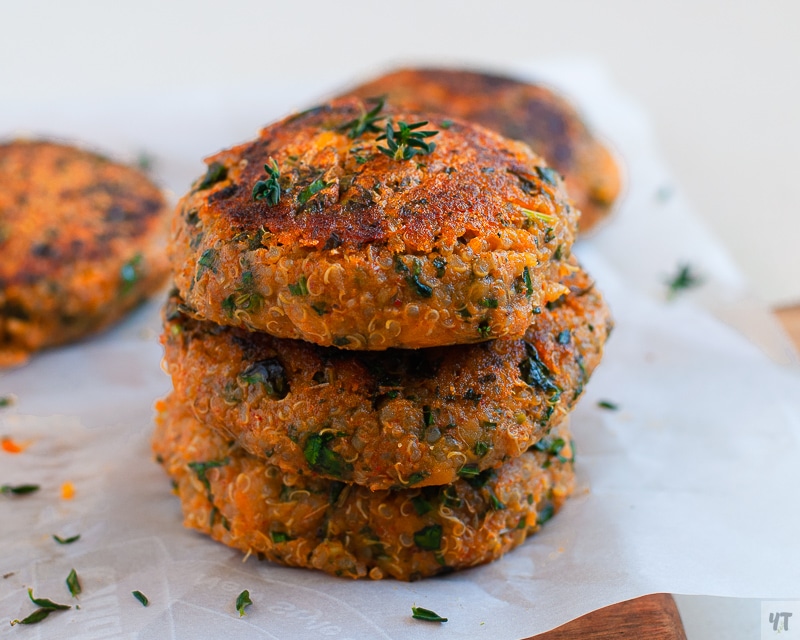 Stacked Sweet Potato and Kale Patties on Parchment paper.
