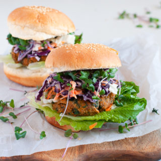 A gluten free and vegan Sweet Potato and Kale Patty on a gluten free bun with a lettuce and slaw topping.