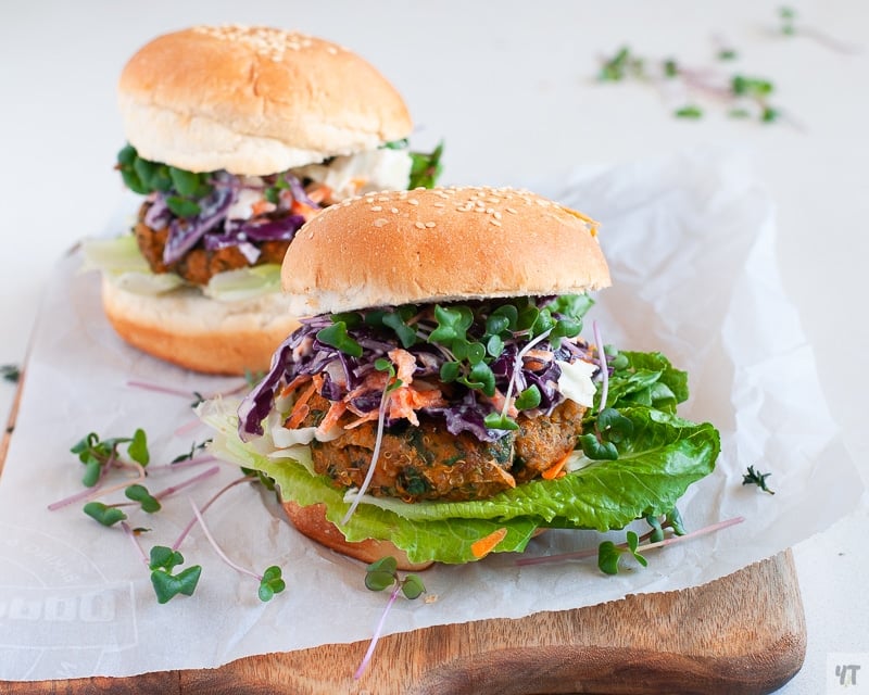 A gluten free and vegan Sweet Potato and Kale Patty on a gluten free bun with a lettuce and slaw topping.