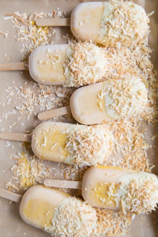 6 mango jackfruit popsicles covered with white chocolate, dipped in toasted coconut.