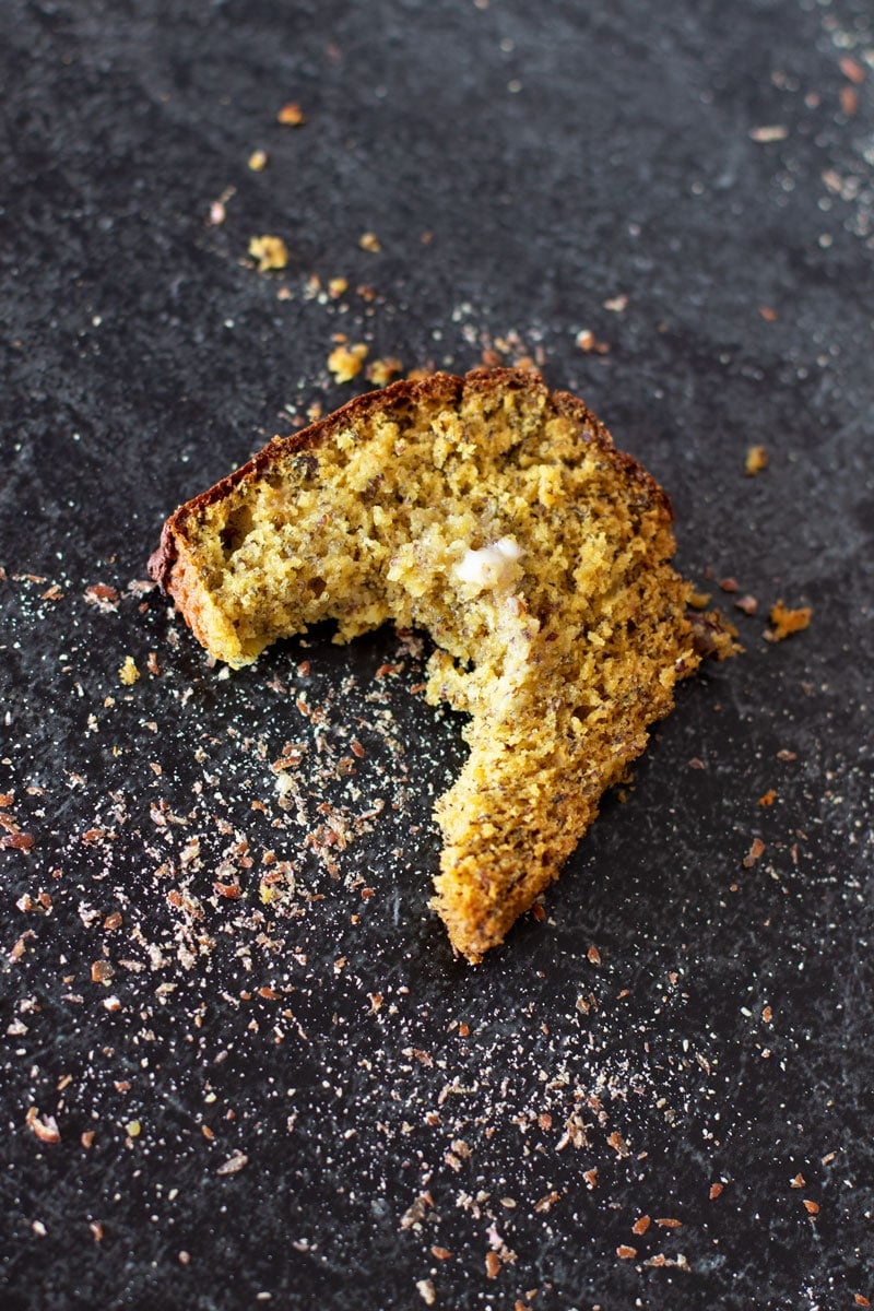 Piece of quinoa banana bread with a bite taken out.