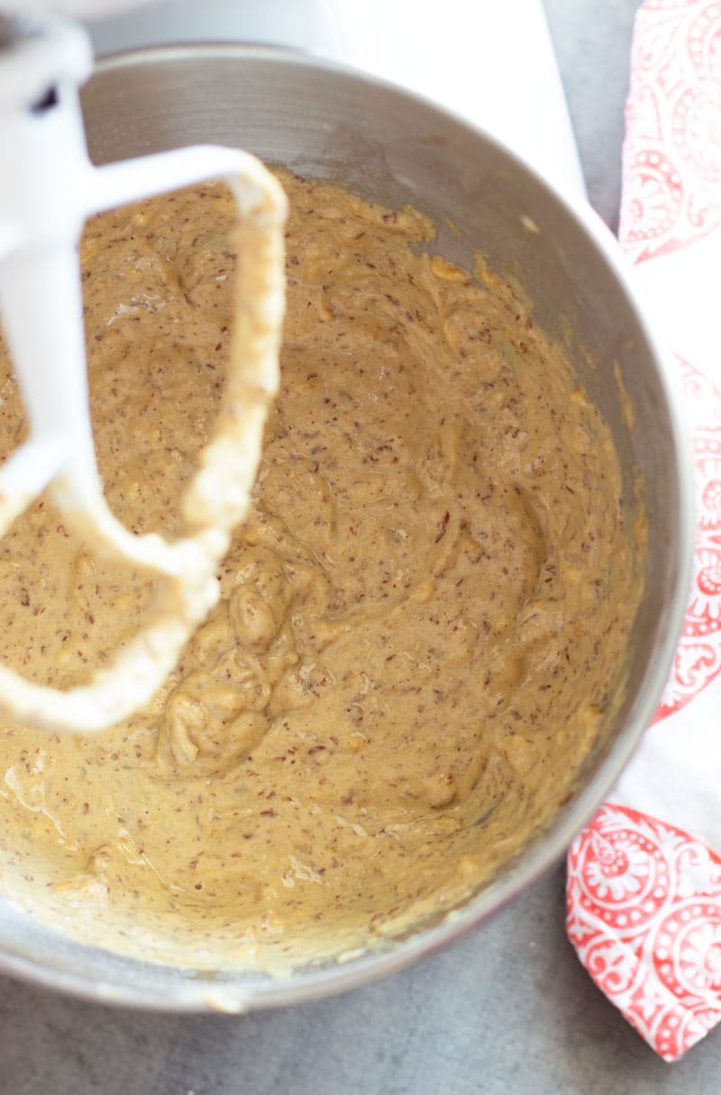 Bowl containing bread mixture being mixed with a KitchenAid mixer.