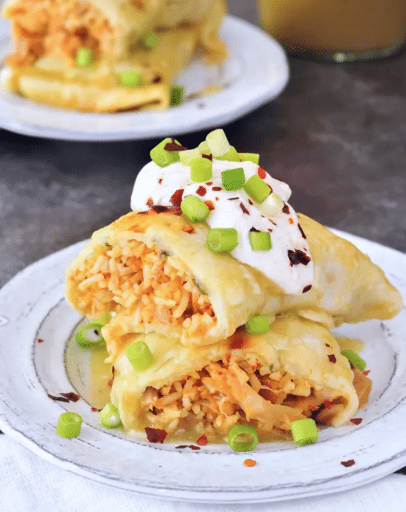 Vegan enchilada topped with sour cream and chives.