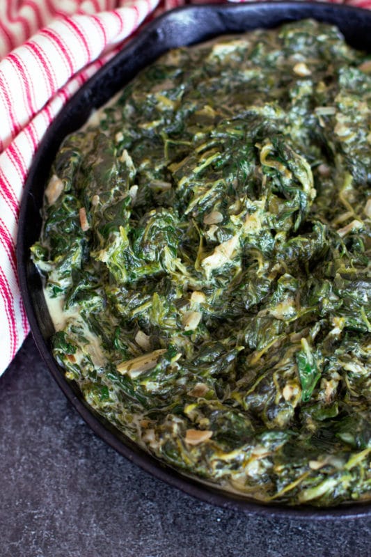 Cast iron skillet containing creamed spinach. 