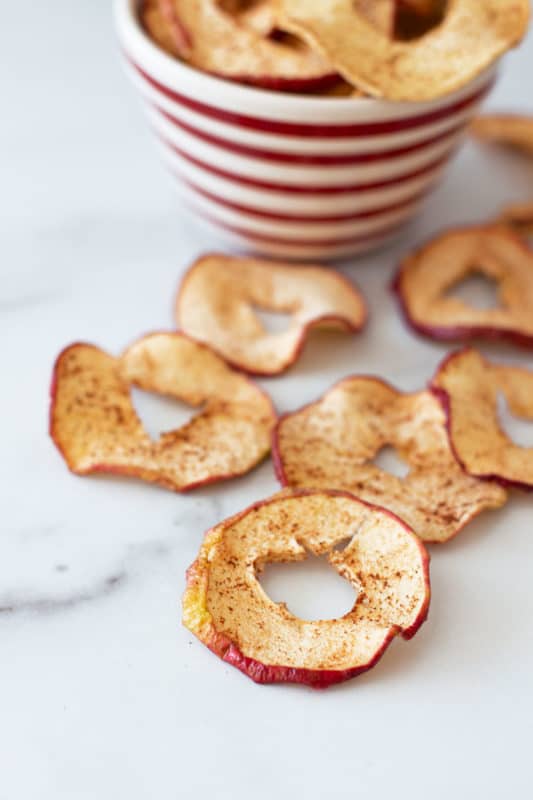 Dried apple rings on marble counter.