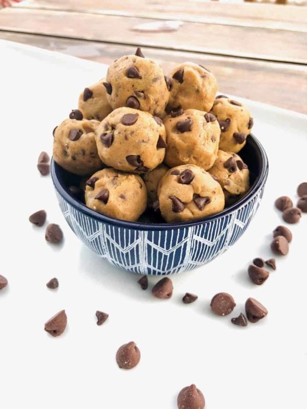 Cookie dough balls with chocolate chips in a bowl.