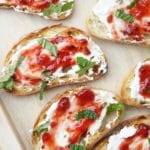 crostini with strawberry preserve, cheese and mint.