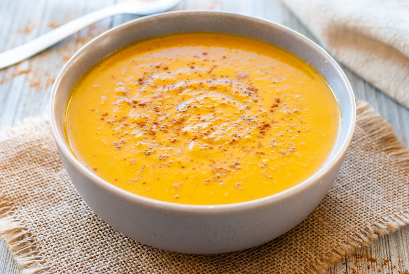 Sweet potato soup in bowl topped with cinnamon.
