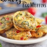 mini egg muffins made with spinach stack on plate.