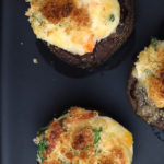 Close up of baked mushrooms topped with roasted breadcrumbs.