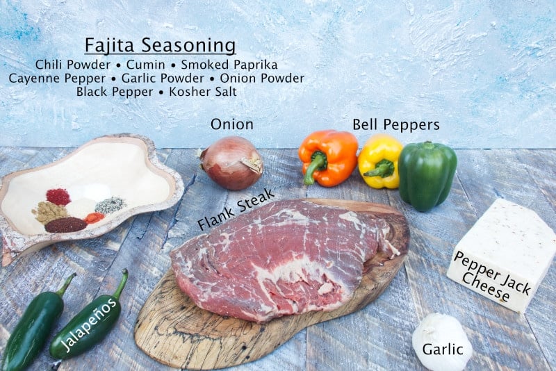ingredients for fajita stuffed flank steak, flank steak, bell peppers, onions, garlic, pepper jack cheese, jalapeños, smoked paprika, cumin, garlic powder, onion powder, salt, pepper