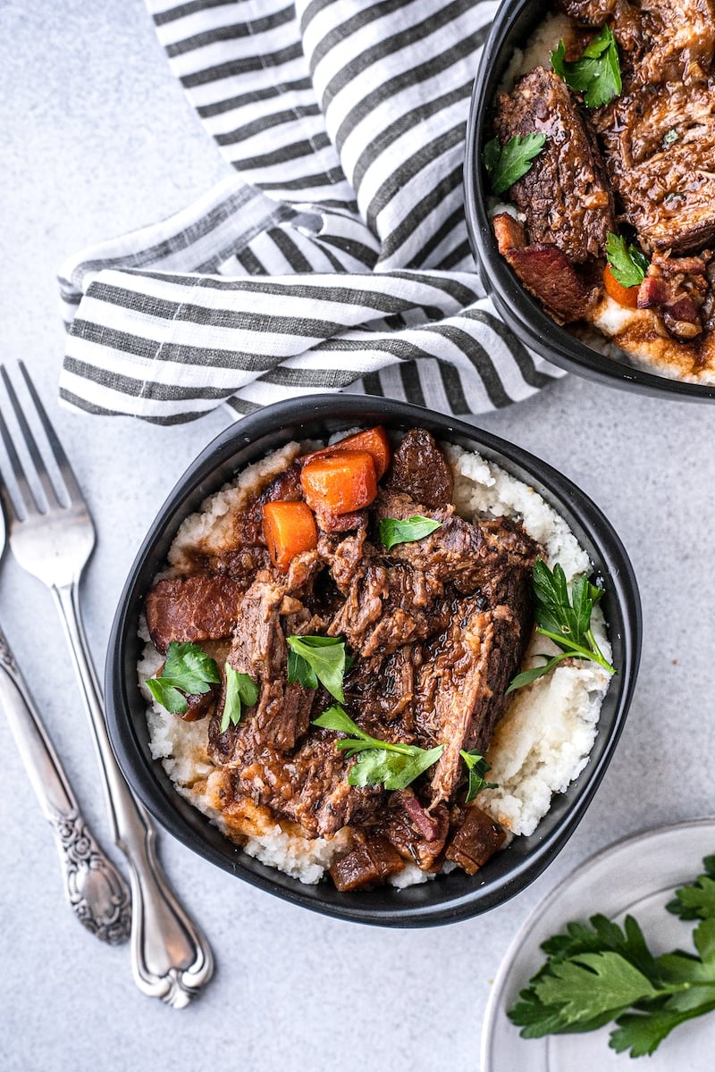 two black bowls with low-carb braised beef and cauliflower mash
