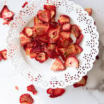 White plate containing dried strawberries