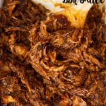 Slow cooker pulled pork in a glass dish.