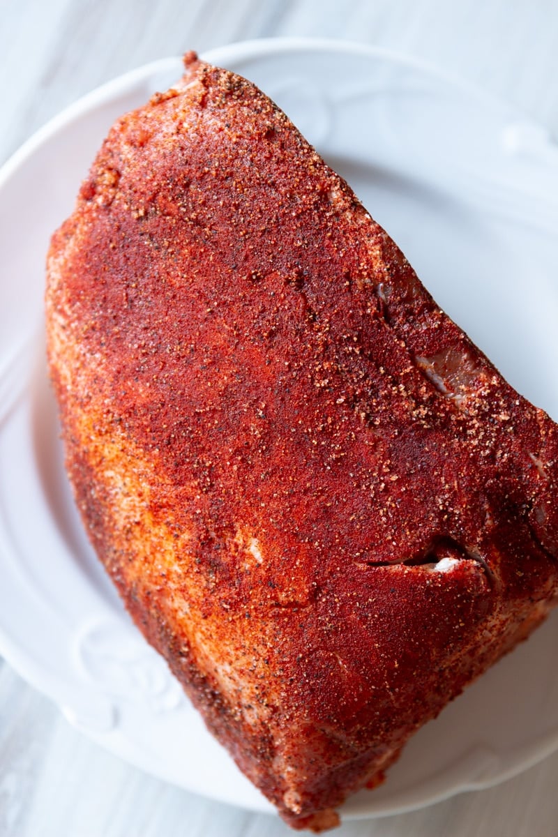 Seasoned pork butt on a plate.
