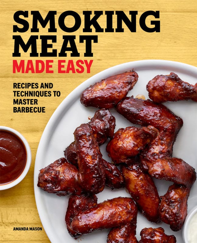 Book cover featuring smoked chicken wings, barbecue sauce on table. 