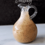 Bottle of Poppyseed and Balsamic Dressing on a counter.