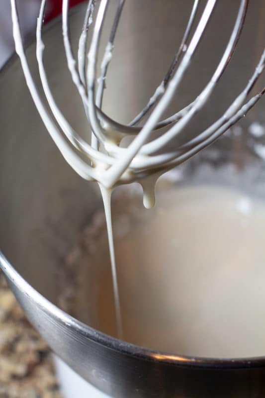 Wire whisk being used to make vanilla icing. 