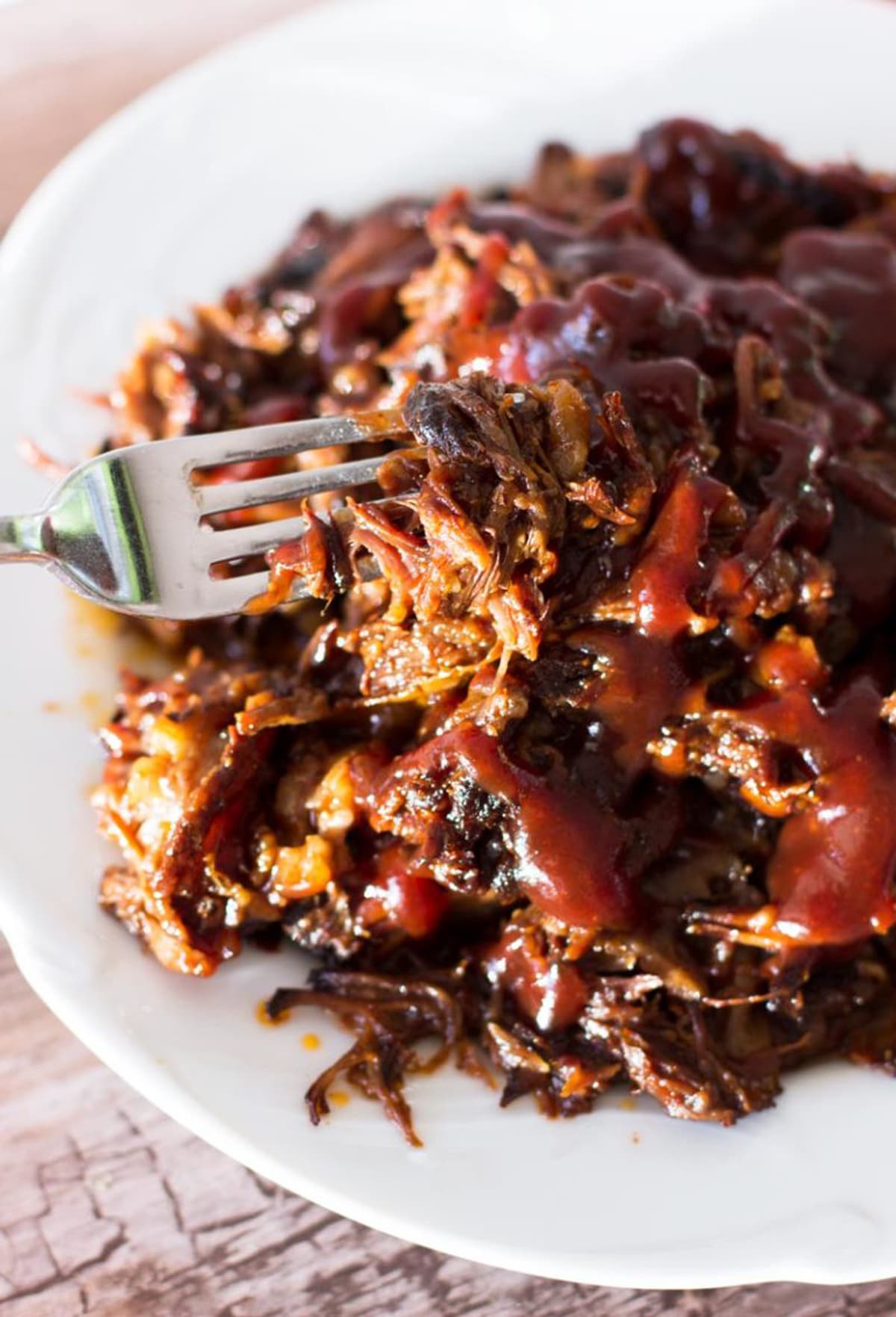 Person using a fork to eat pulled bbq short rib.s