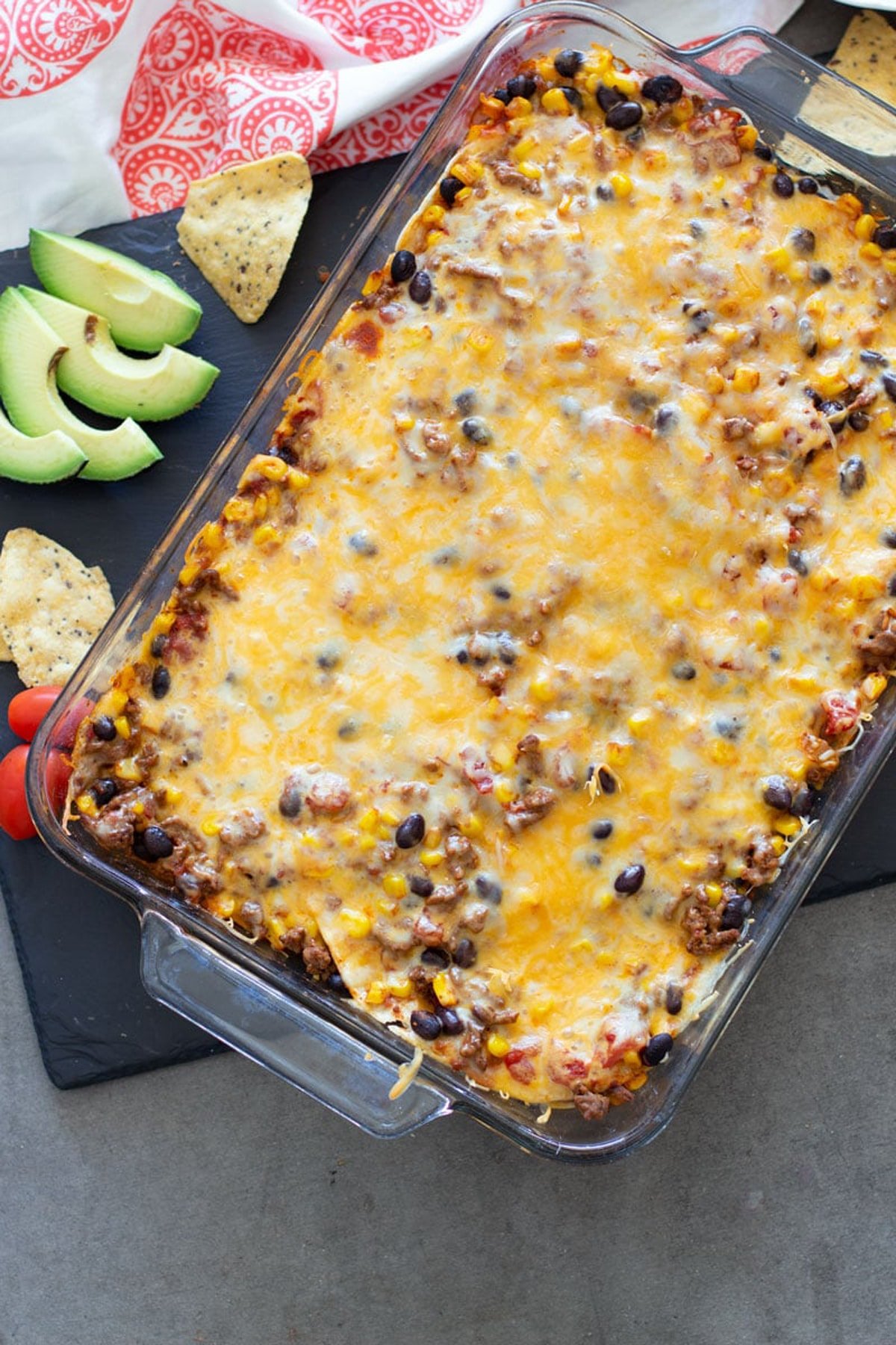 Beef and bean enchilada casserole in glass casserole dish