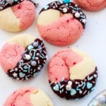 Six Neapolitan Cookies topped with sprinkles and dipped in dark chocolate.